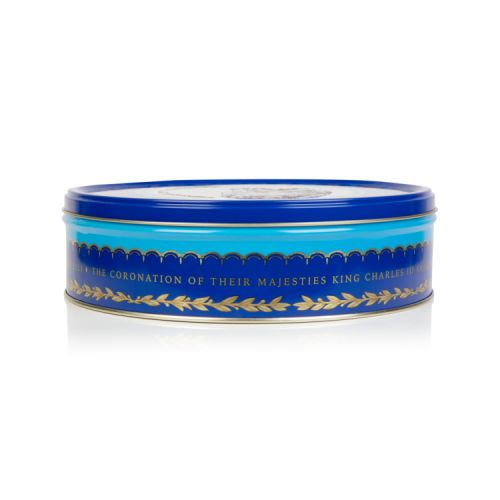 Blue round biscuit tin featuring the Royal coat of arms at the centre of the tin including the lion and the unicorn. Surrounding the coat of arms is a border of golden daffodils, roses, shamrocks and thistles. The tin is open to show the shortbreads insid