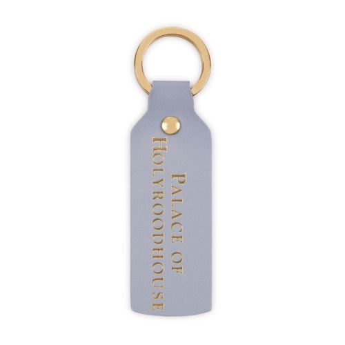 Front of keyring with purple Palace of Holyroodhouse crest against lilac background. 