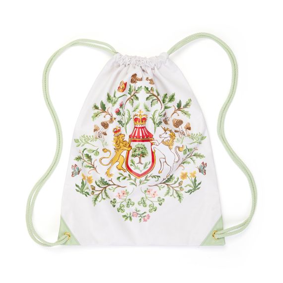 A drawstring bag featuring pastel green cord straps and with illsuatrion featuring the Royal Coat of Arms, surrounded with British wildflowers foliage, and garden wildlife such as birds, bees, and butterflies. A drawstring bag featuring pastel green cord straps and with illsuatrion featuring the Royal Coat of Arms, surrounded with British wildflowers foliage, and garden wildlife such as birds, bees, and butterflies.