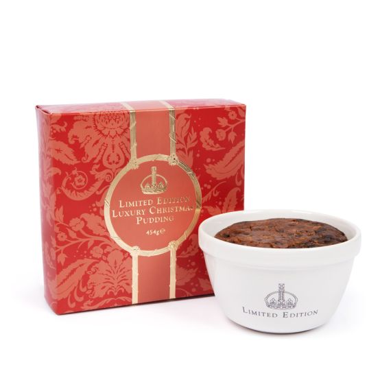 Ceramic pudding basin featuring "Limited edition" and a crown on the bowl next to the packging the box comes in with a festive red acanthus pattern and gold detailing. Ceramic pudding basin featuring "Limited edition" and a crown on the bowl next to the packging the box comes in with a festive red acanthus pattern and gold detailing.