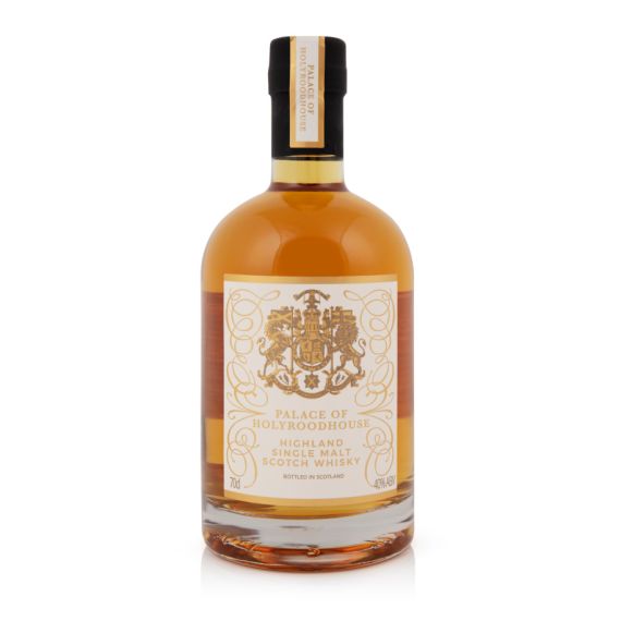 Bottle of whisky with white and gold label. Royal Coat of Arms and information written on label. Bottle of whisky with white and gold label. Royal Coat of Arms and information written on label.